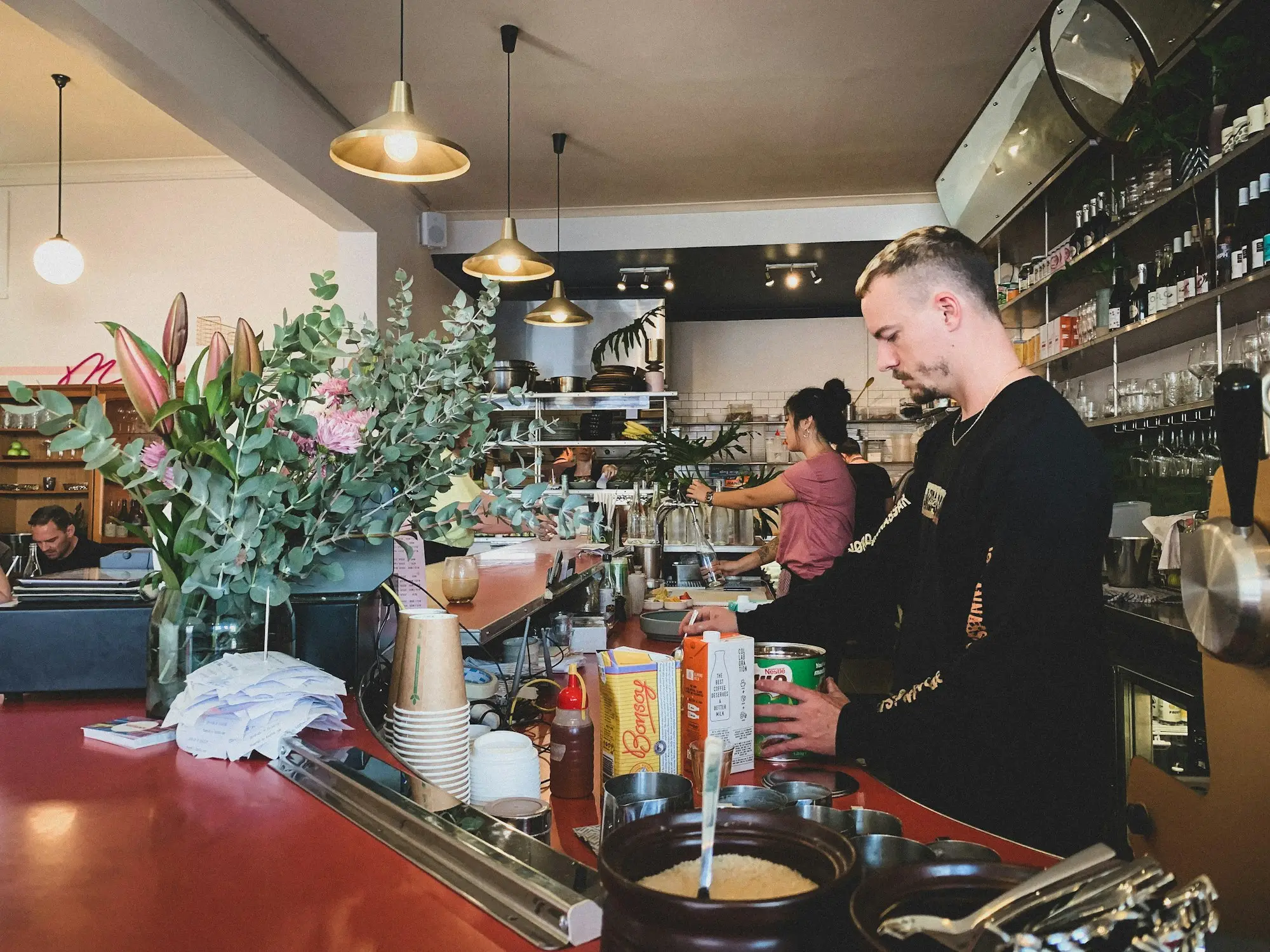 Cafe owner working behind the counter of a Redfern cafe in Sydney