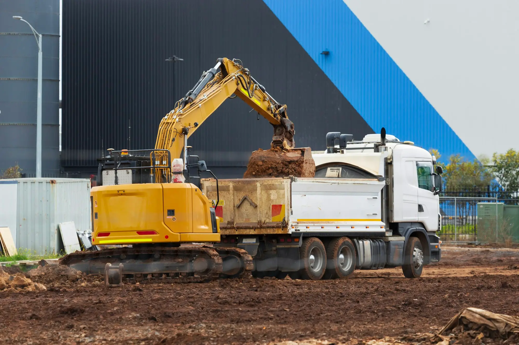 Excavator loading a tipper truck on a building site in Truganina, Victoria