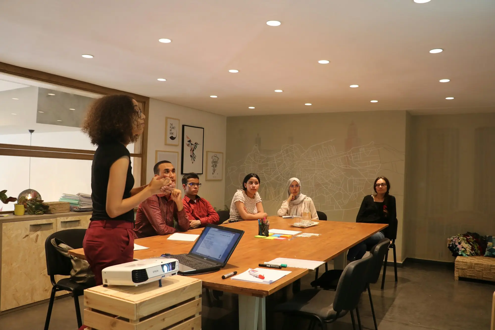 New hires and managers meeting around a workshop table