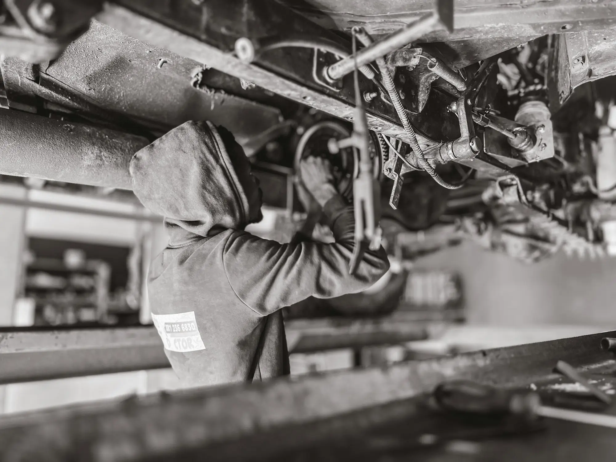 Mechanic repairing worn machinery in a workshop
